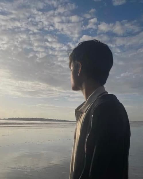 Arman Singh standing beside the water